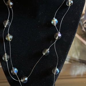 42” necklace of single crystals strung on clear nylon line. Beads are 2” apart.